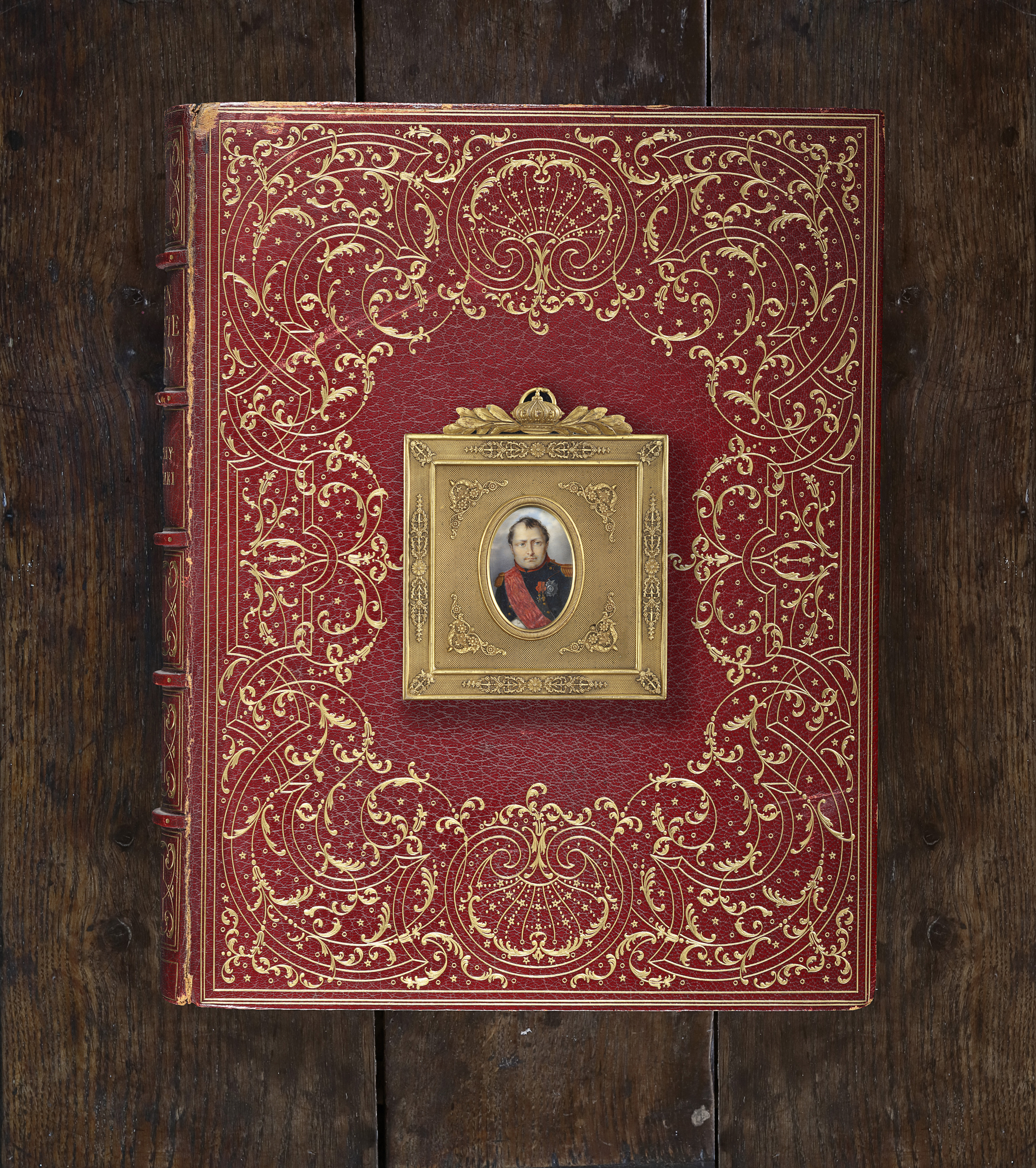 Portrait miniature of the Emperor Napoleon (1769-1821), wearing the dark green uniform with red piping of chasseur-a-cheval de la Garde Imperial, the red sash, badge and star of the Légion d’honneur, and badge of the Iron Crown of Lombardy