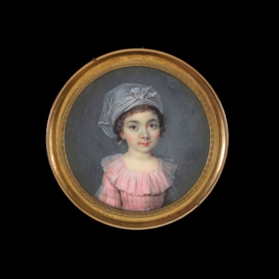 Portrait of a young girl, wearing a pink dress and gauze headdress