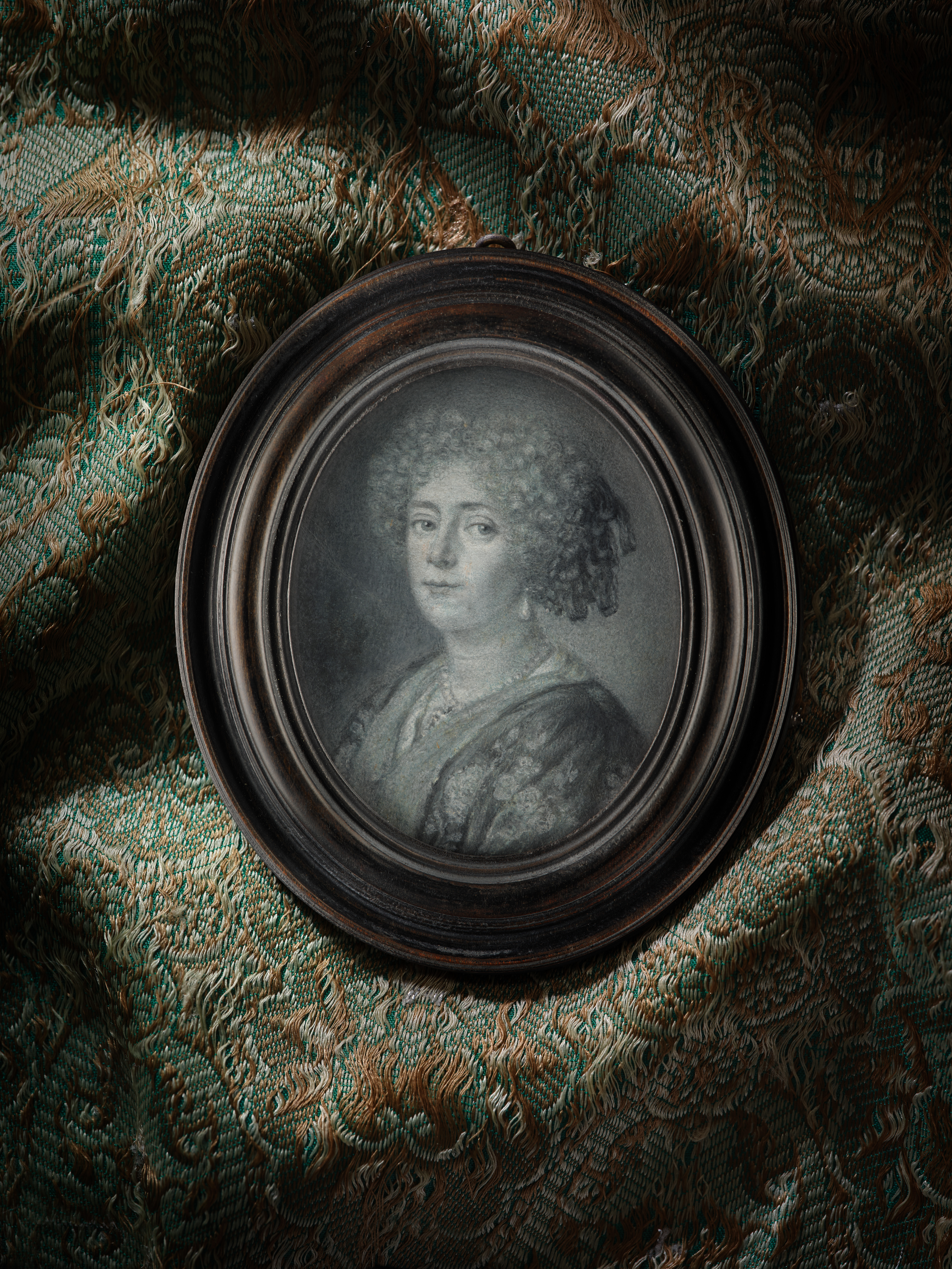 Portrait of a Noblewoman, possibly Anne-Marie d'Orléans Longueville, duchesse de Nemours (1625-1707), wearing floral embroidered ‘banyan’ over white gown, pearl necklace and large pearl earrings, her curled hair decorated with ribbons