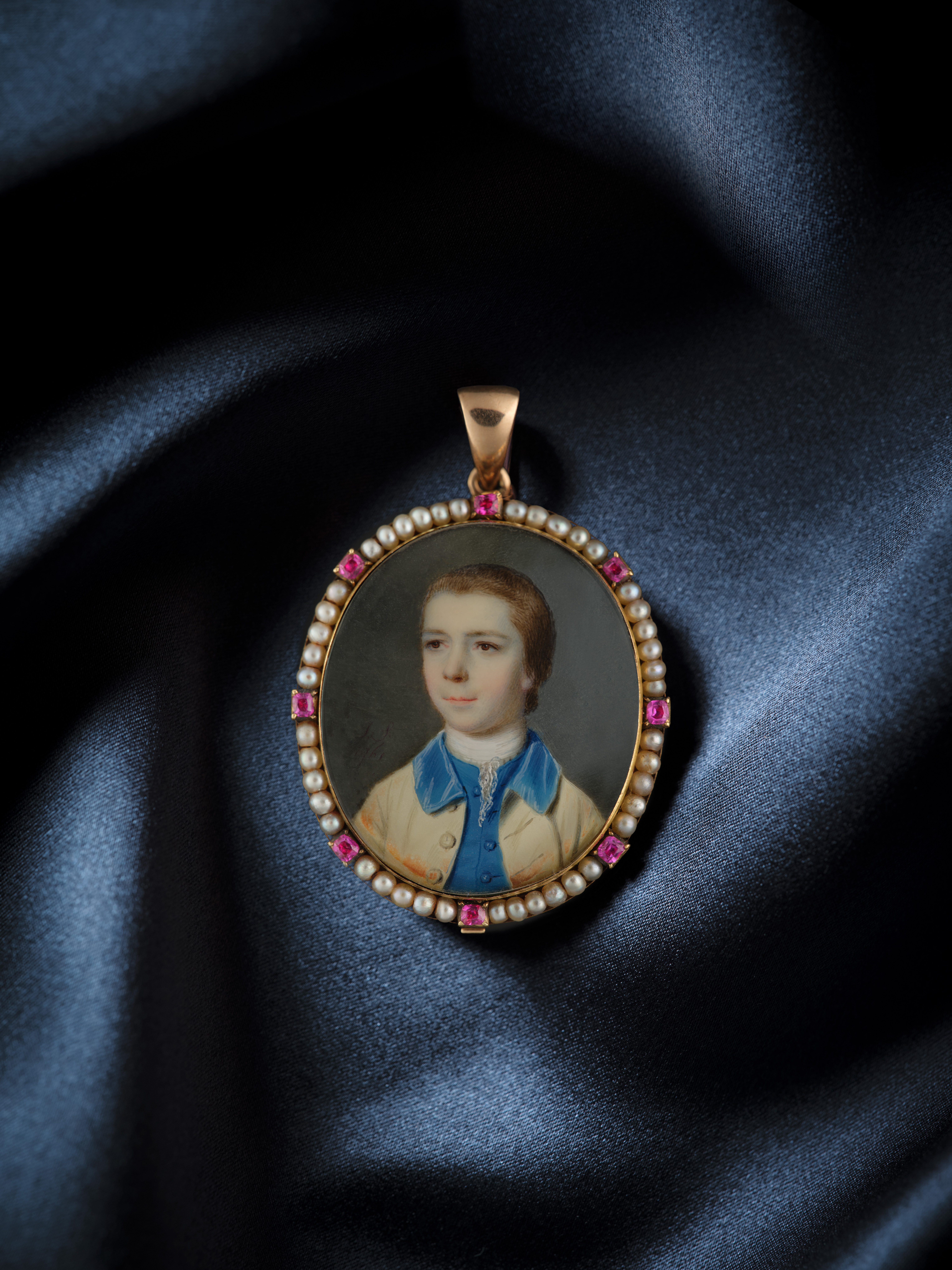 Portrait miniature of a young Boy, wearing cream coat with blue velvet collar and matching waistcoat