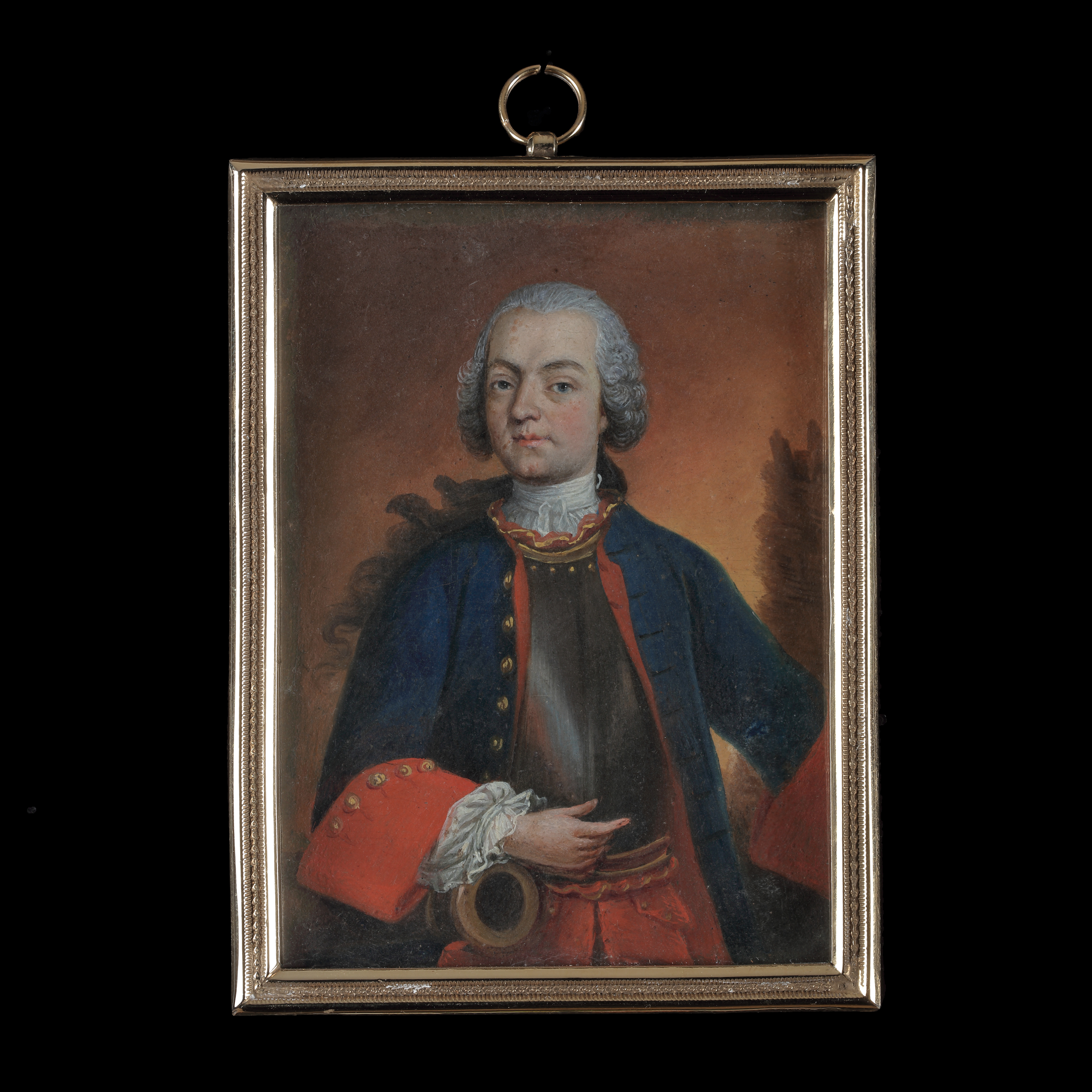 Portrait miniature of an Artillery Officer in uniform, wearing a blue jacket with red facings, and a plate of armour, his right arm resting on the muzzle of a cannon