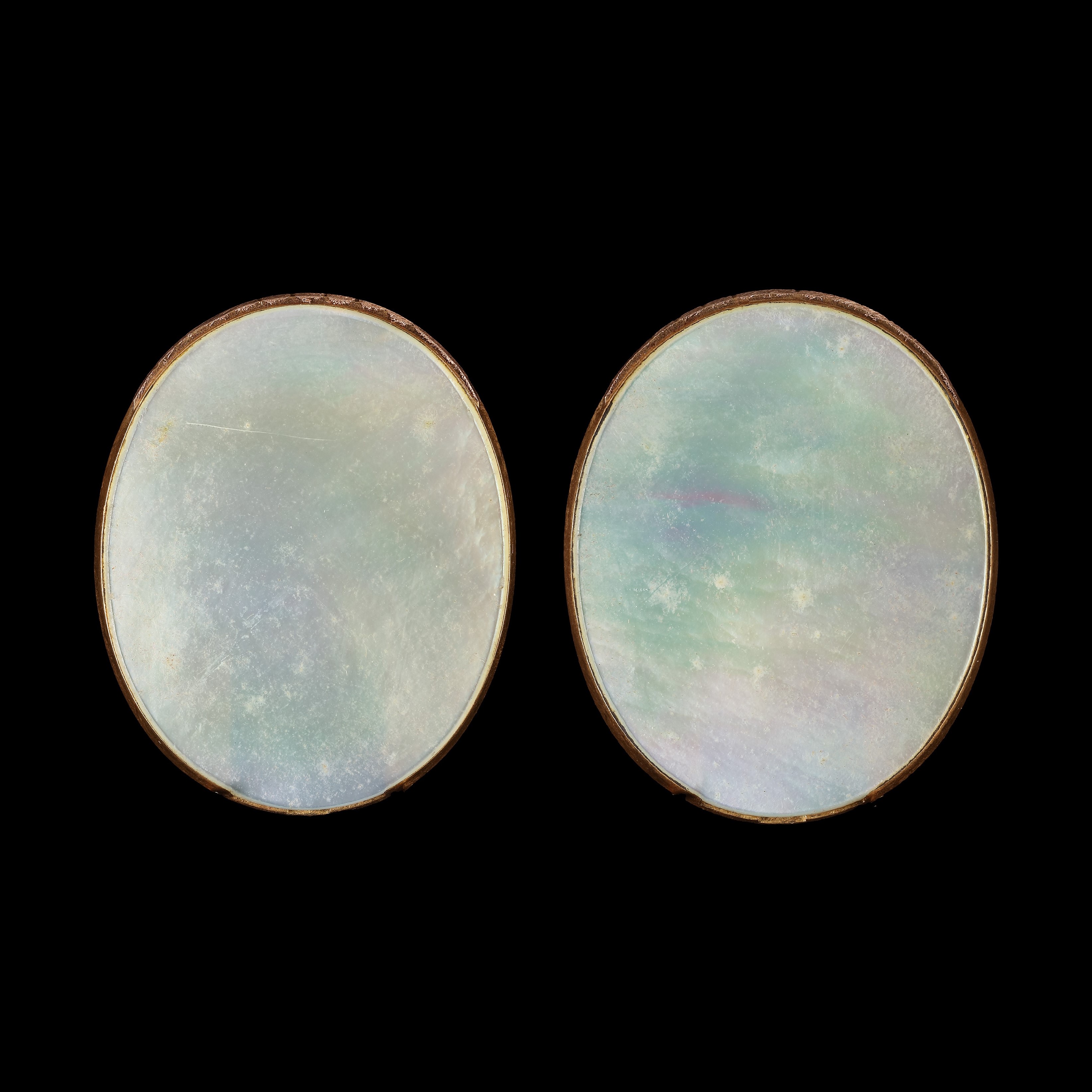 Pair of portrait enamels of husband and wife Sir William Wheler (1702-1763), 5th Bart of the City of Westminster and Lady Penelope Wheler (née Glynne) (1706-1740); he wearing blue coat and red waistcoat; she in white open-fronted gown with lace underdress