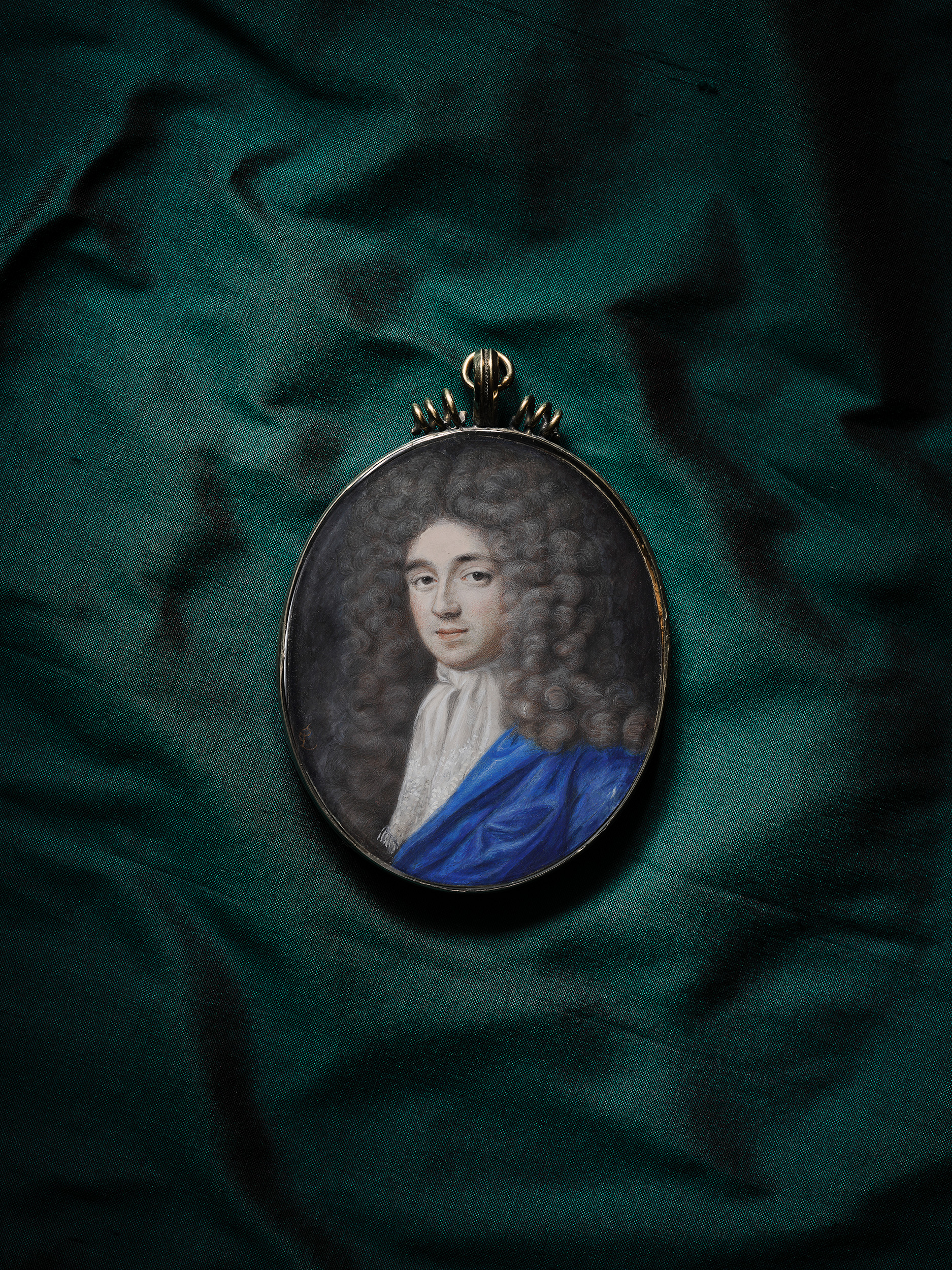 Portrait miniature of a Gentleman, wearing white jabot decorated with white embroidery, blue robes, powdered wig