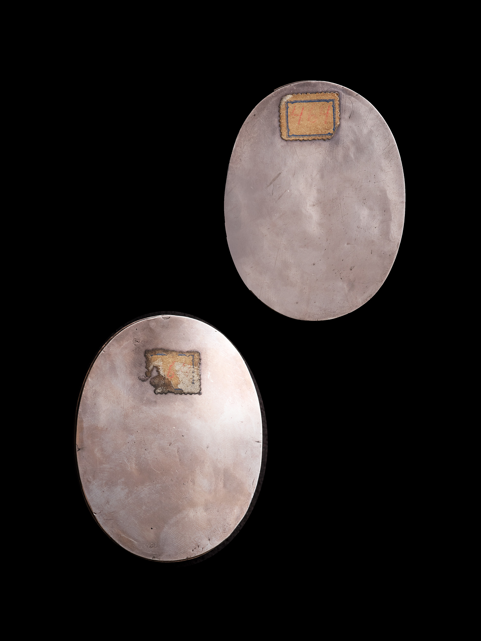 A pair of oil portraits, presumably Husband and Wife; he wearing armour, lawn collar and a red sash around his arm; she wearing lace-trimmed blue dress with diamond and pearl brooch, pearls and pearl-drop earrings