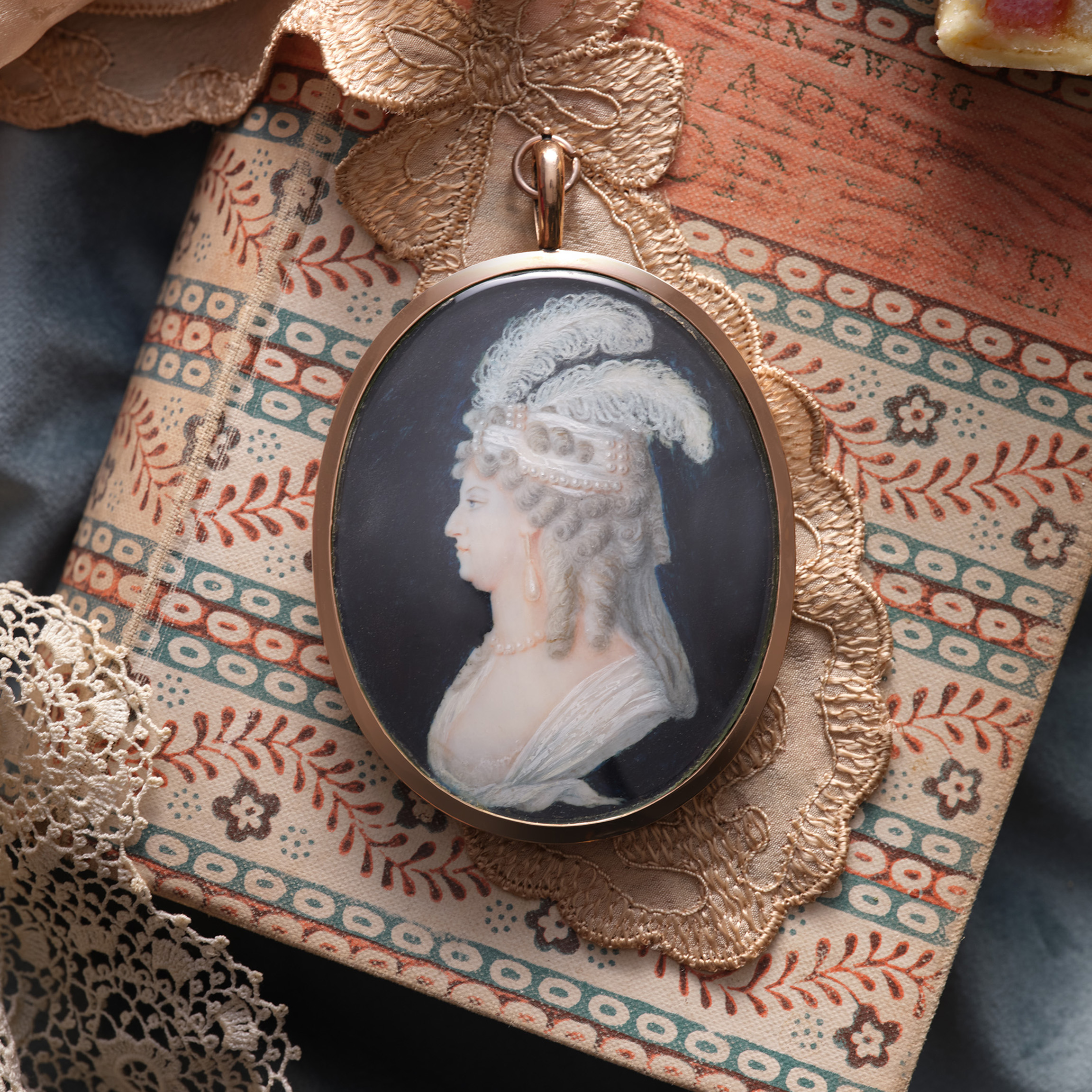 Portrait miniature of Marie-Antoinette, Queen of France (1755-1793), profile to the left, wearing white gown, pearl necklace and earrings and pearl and ostrich feather bandeau over the powdered hair