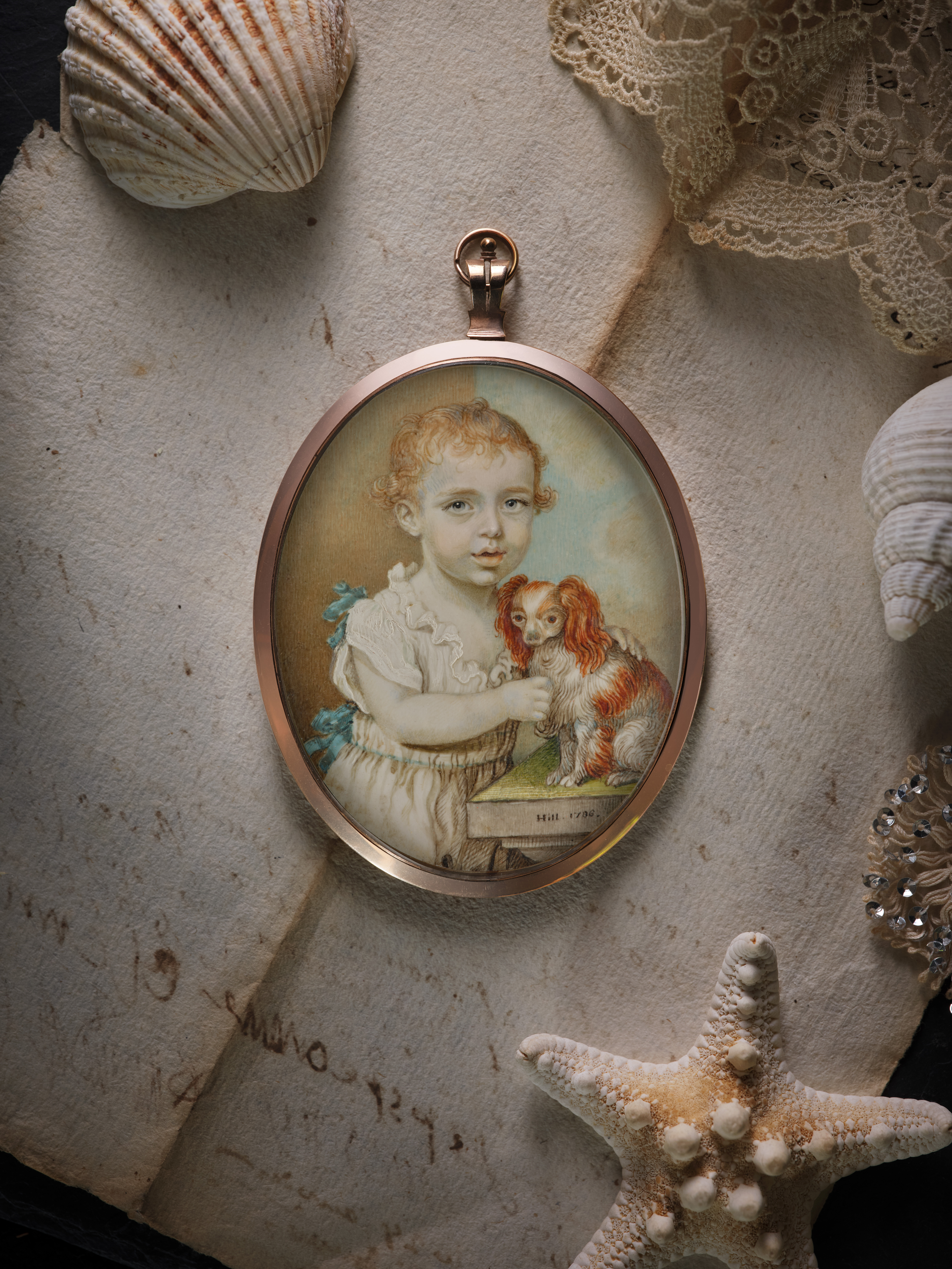 Portrait miniature of a Child, possibly of the Graham family, wearing white cotton smock and holding a spaniel on a stone plinth