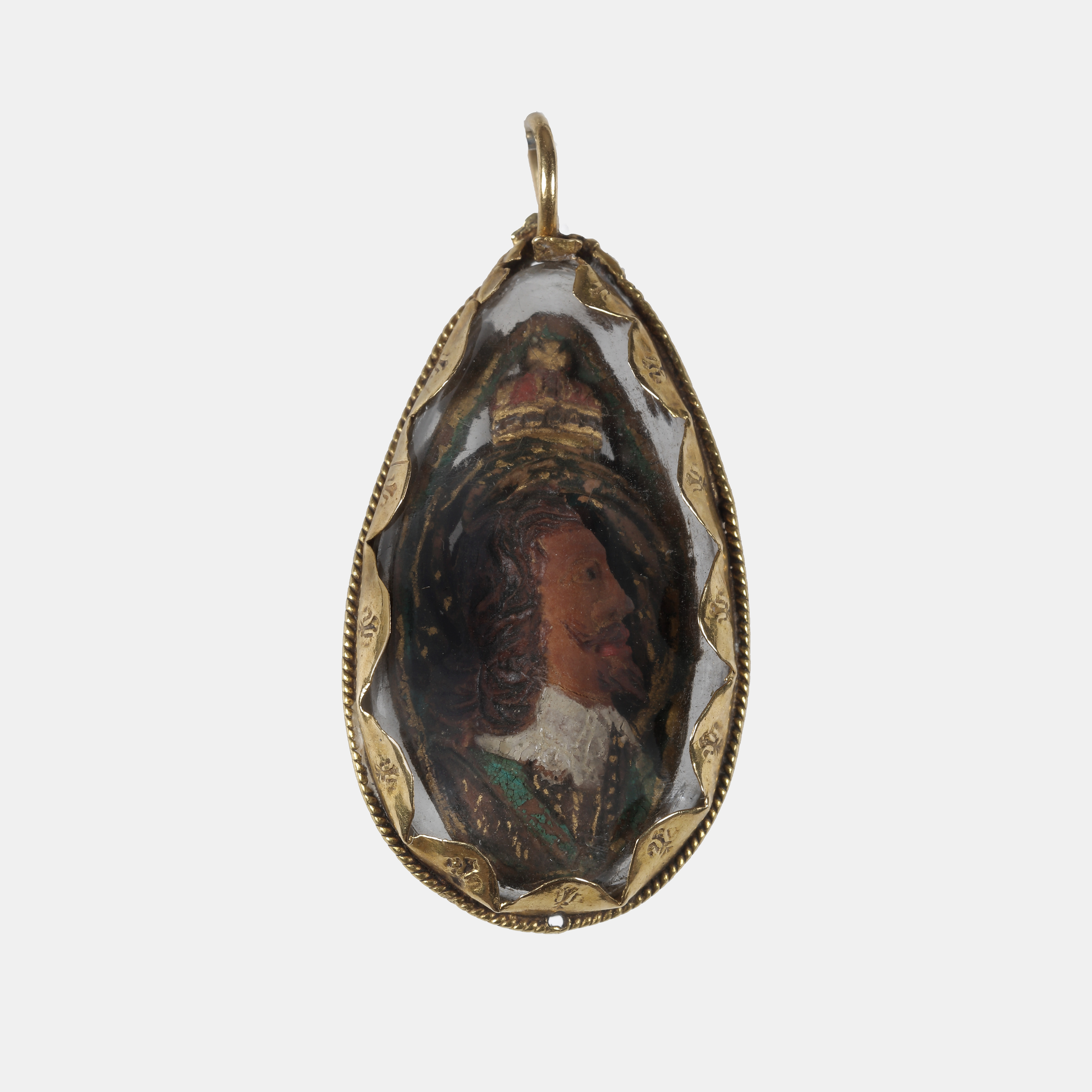 A fruit stone (probably a plum or peach stone) carved on both sides with portraits of King Charles I and King Charles II, with royal insignia