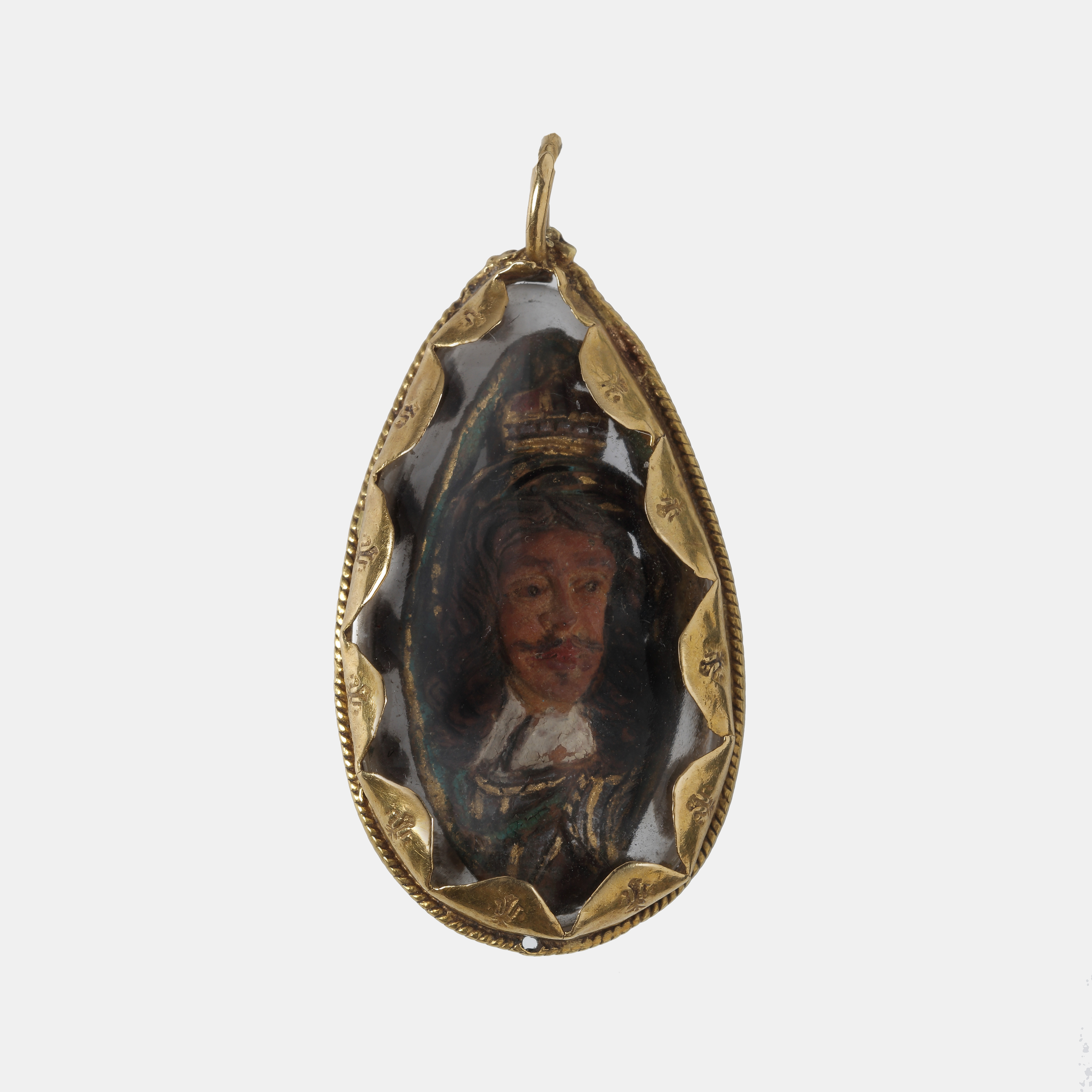 A fruit stone (probably a plum or peach stone) carved on both sides with portraits of King Charles I and King Charles II, with royal insignia