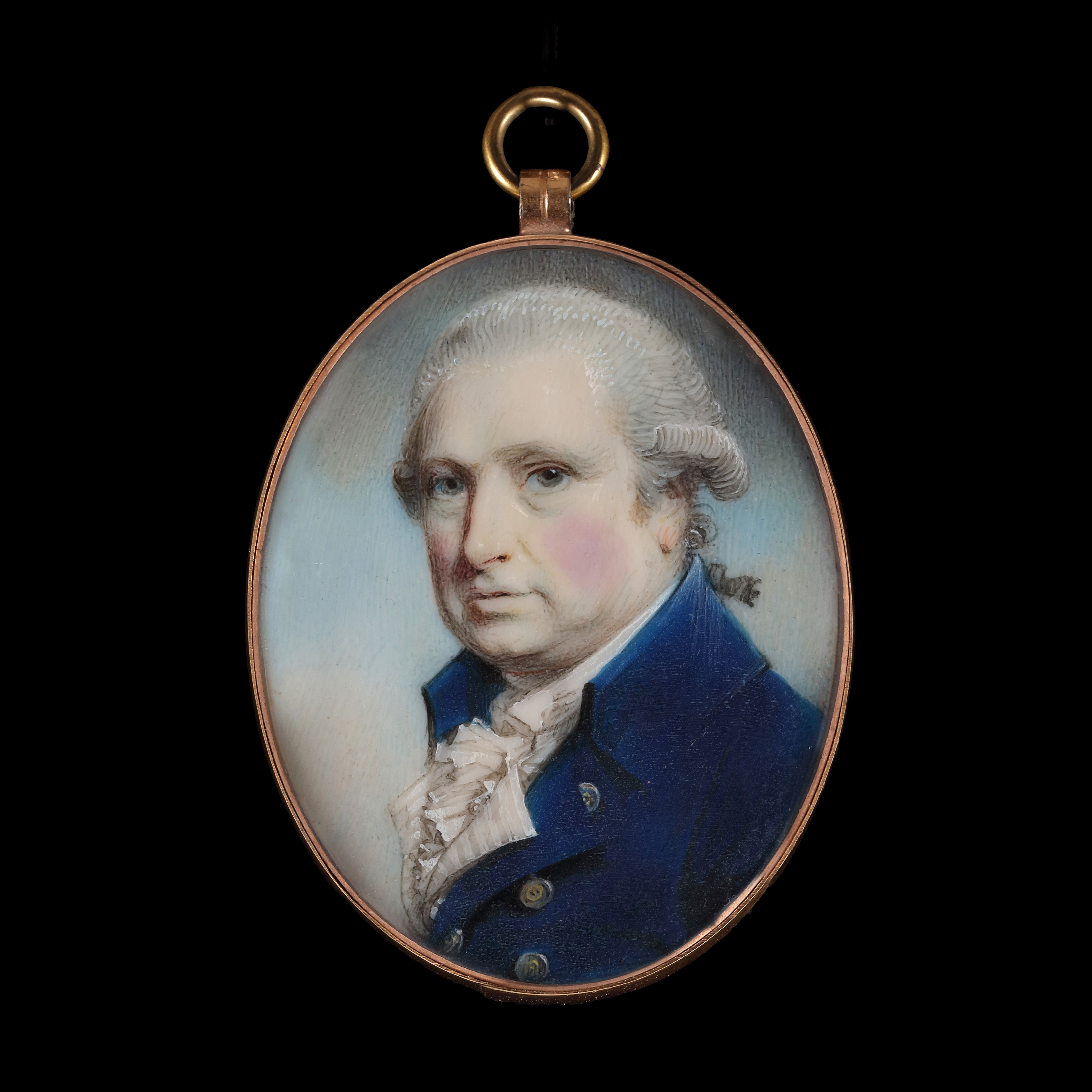 Portrait miniature of a Gentleman, wearing a blue coat with a high collar, a white striped waistcoat, white shirt and frilled cravat, his powdered wig worn 'en queue'