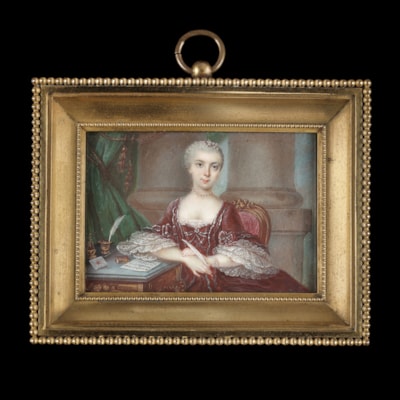 Portrait miniature of a Lady in a Maroon dress, with lace sleeves and decorative bows, writing a love letter (which reads ‘mon cher couer/ton absence…’ )