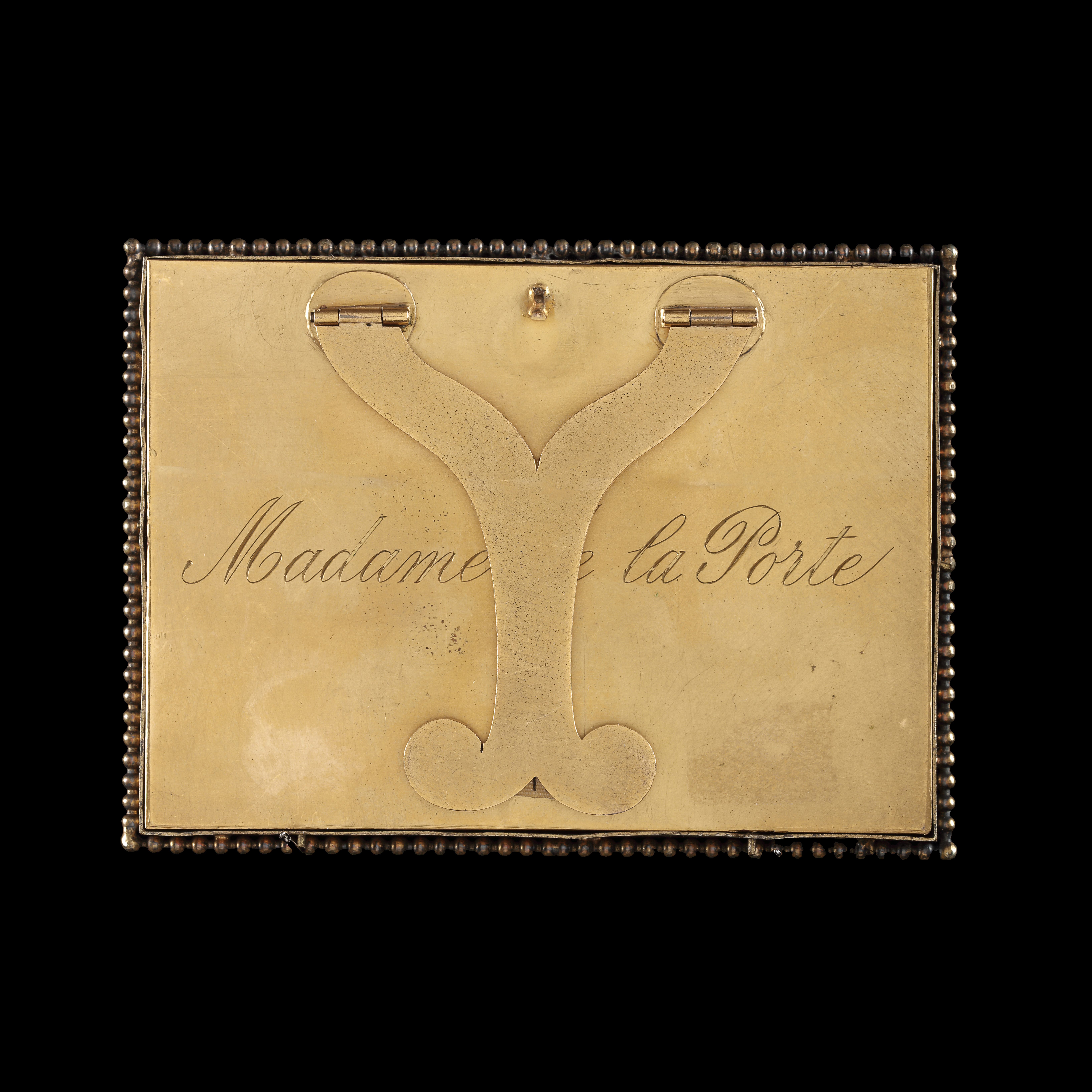 Portrait miniature of Madame de la Porte (Marie-Anne Pellerin de Painville) (1714-1763), wearing a gold silk shawl over a light pink chemise, pearls in her hair and across her arms, gold silk bow around her neck, with a dog on her lap, playing with a green ribbon