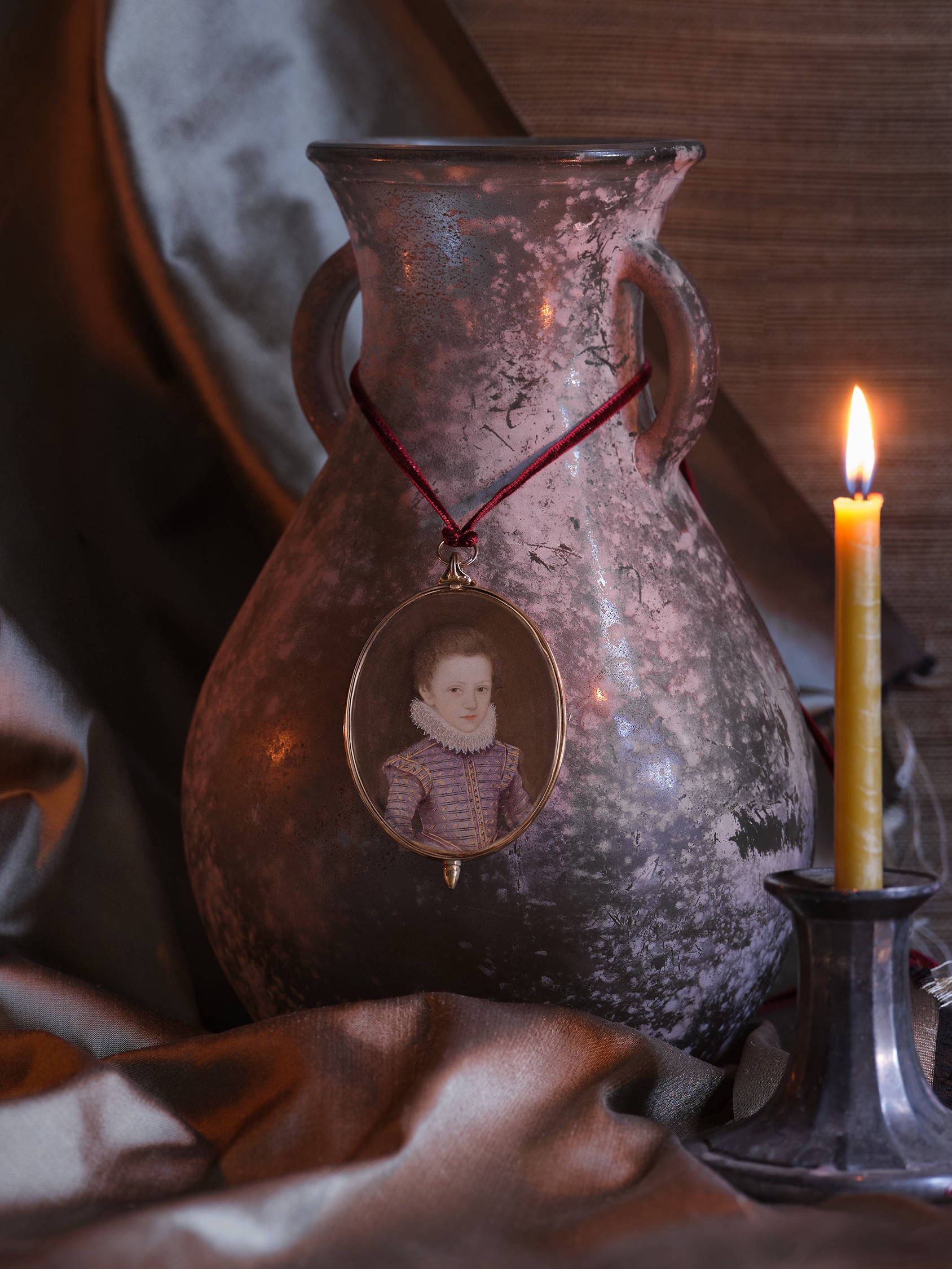 Portrait miniature of a Young Boy, wearing lilac-coloured doublet, slashed and embroidered with gold