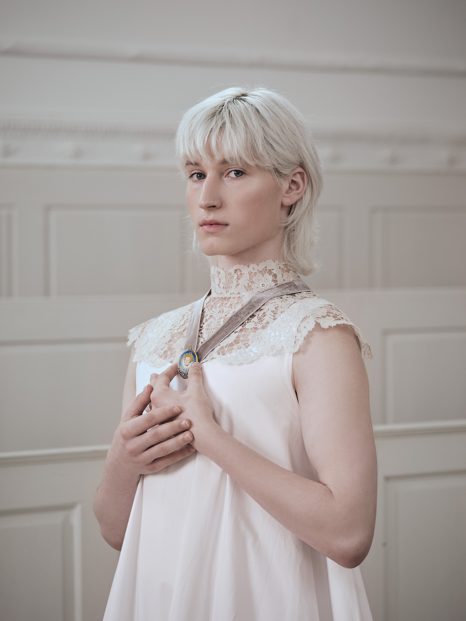 Portrait miniature of a Noblewoman, possibly of Elizabeth, Lady Leighton (née Knollys) (1549-c.1605), wearing court dress in black and white, decorated with white bows and gold and diamond jewels, large ‘cartwheel’ ruff[1]; feather hairpiece and pearl in her curled auburn hair