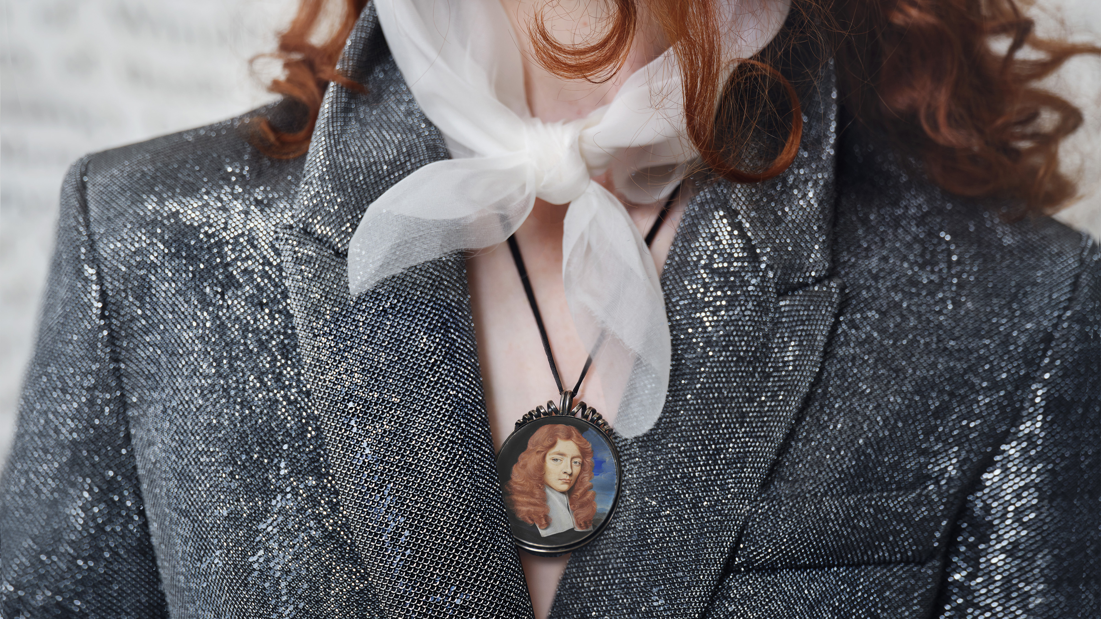 Portrait miniature of a Young Gentleman, wearing black robes and white lawn collar; landscape and cloudy sky background