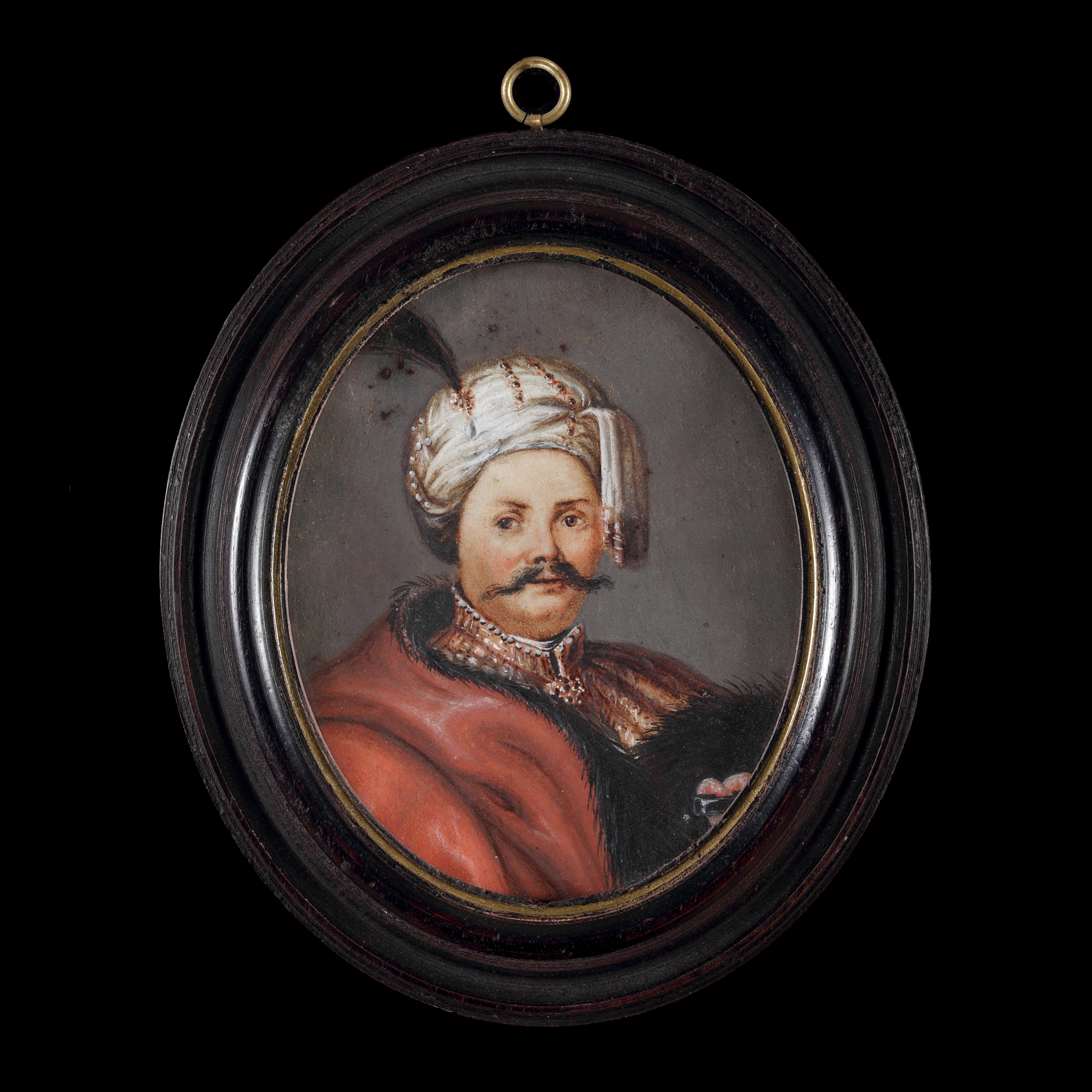 Portrait of Jan III Sobieski (1624-1696), wearing ‘Ottoman’ clothing; a red cloak with black fur trim, a gold embroidered jacket, and a white headdress decorated with pearls and a black feather