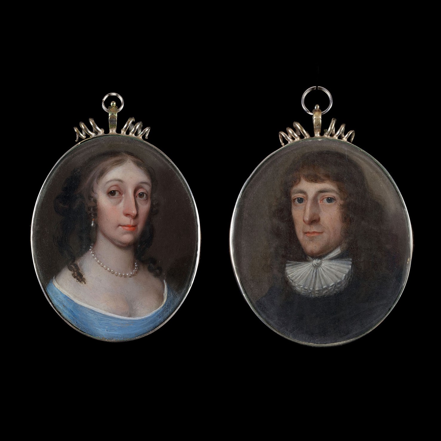 A pair of portraits of  Lady and Gentleman, possibly mother and son, she in a low cut blue dress with pearls, he with a white lace collar and black coat,