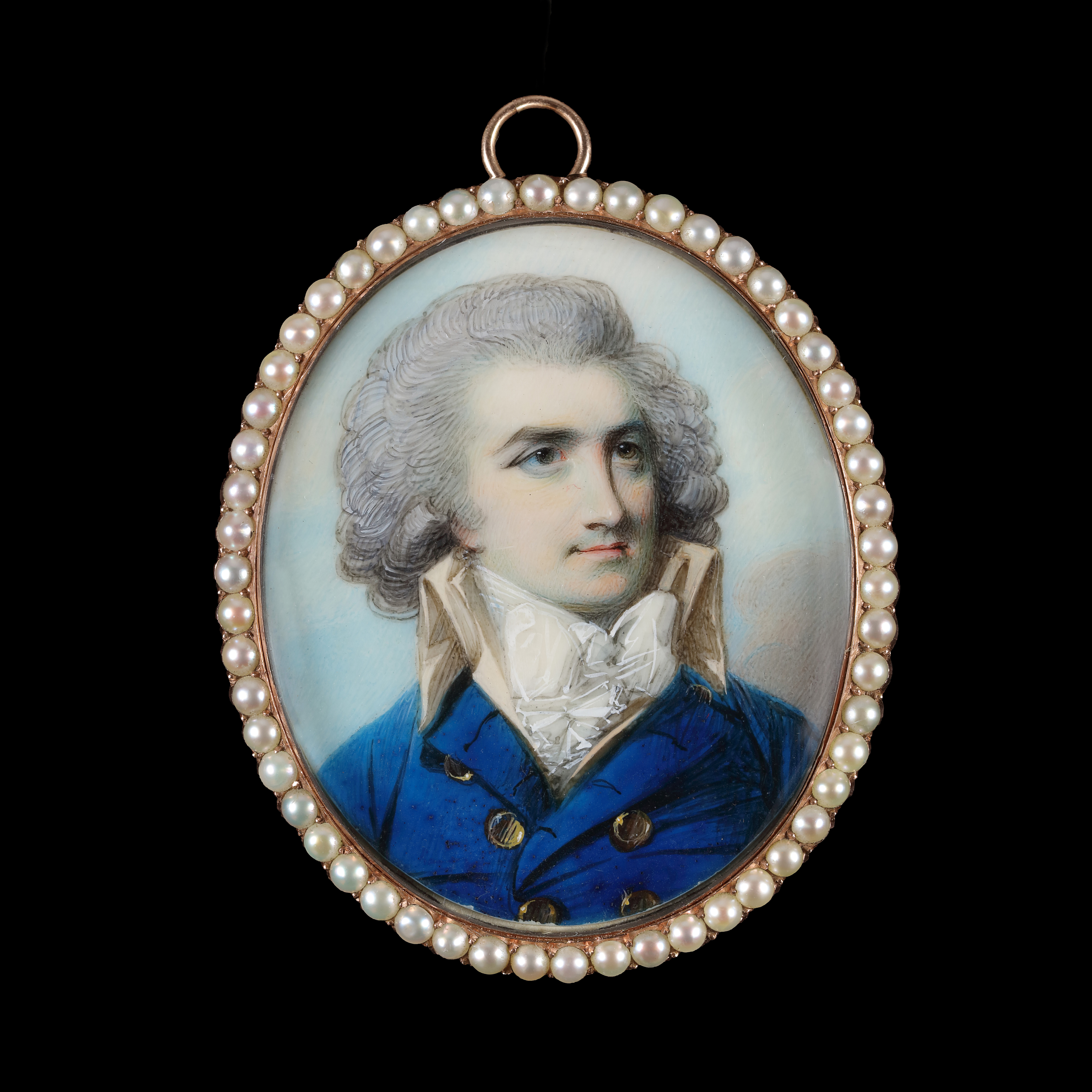 Portrait miniature of a Gentleman wearing a navy blue jacket with a high buff collar and brass buttons; circa 1785