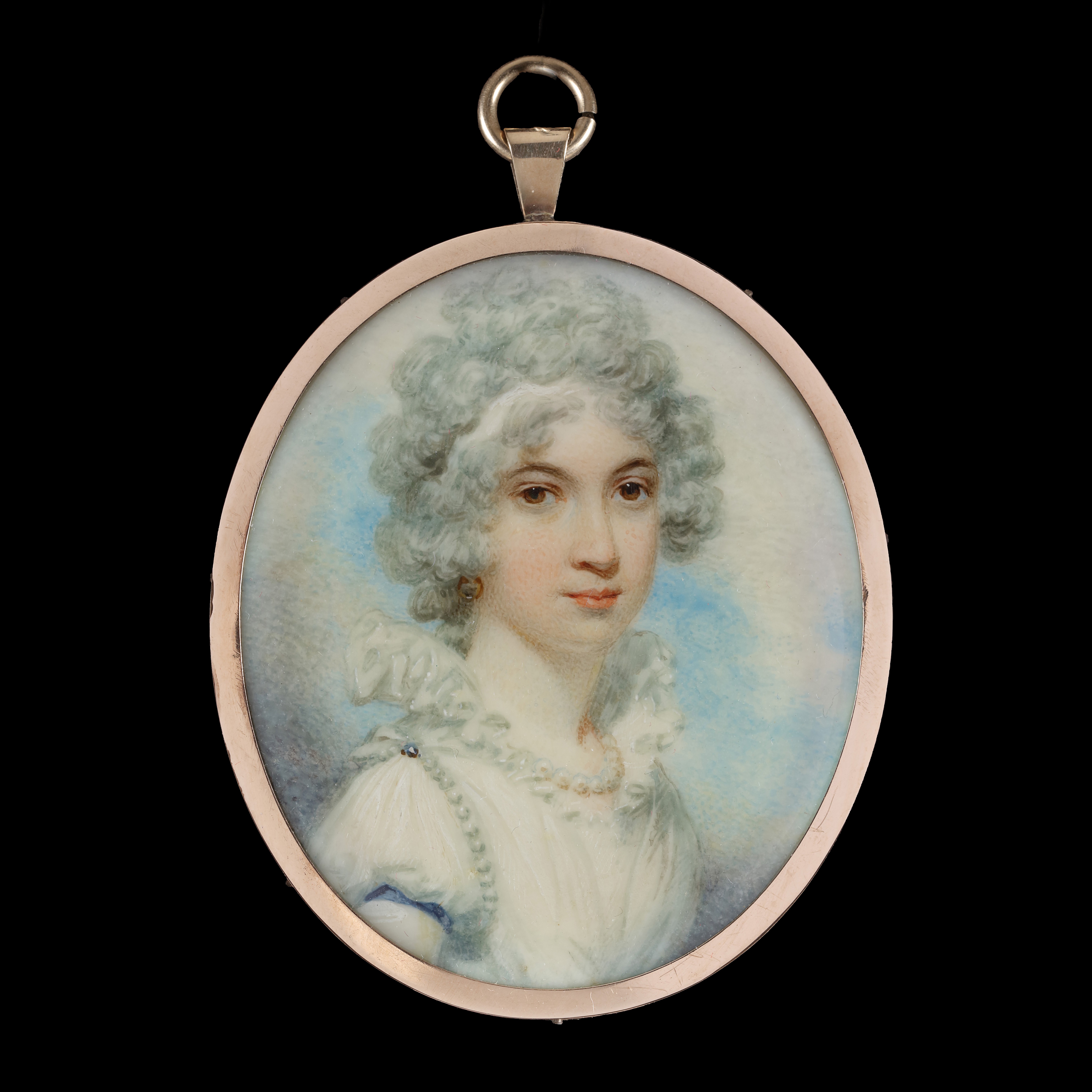 Portrait miniature of a Lady, traditionally called Dorothy McKenzie, wearing a white dress with an upright collar, pearl necklace and shoulder band, white powdered hair, and a hoop earring; circa 1790