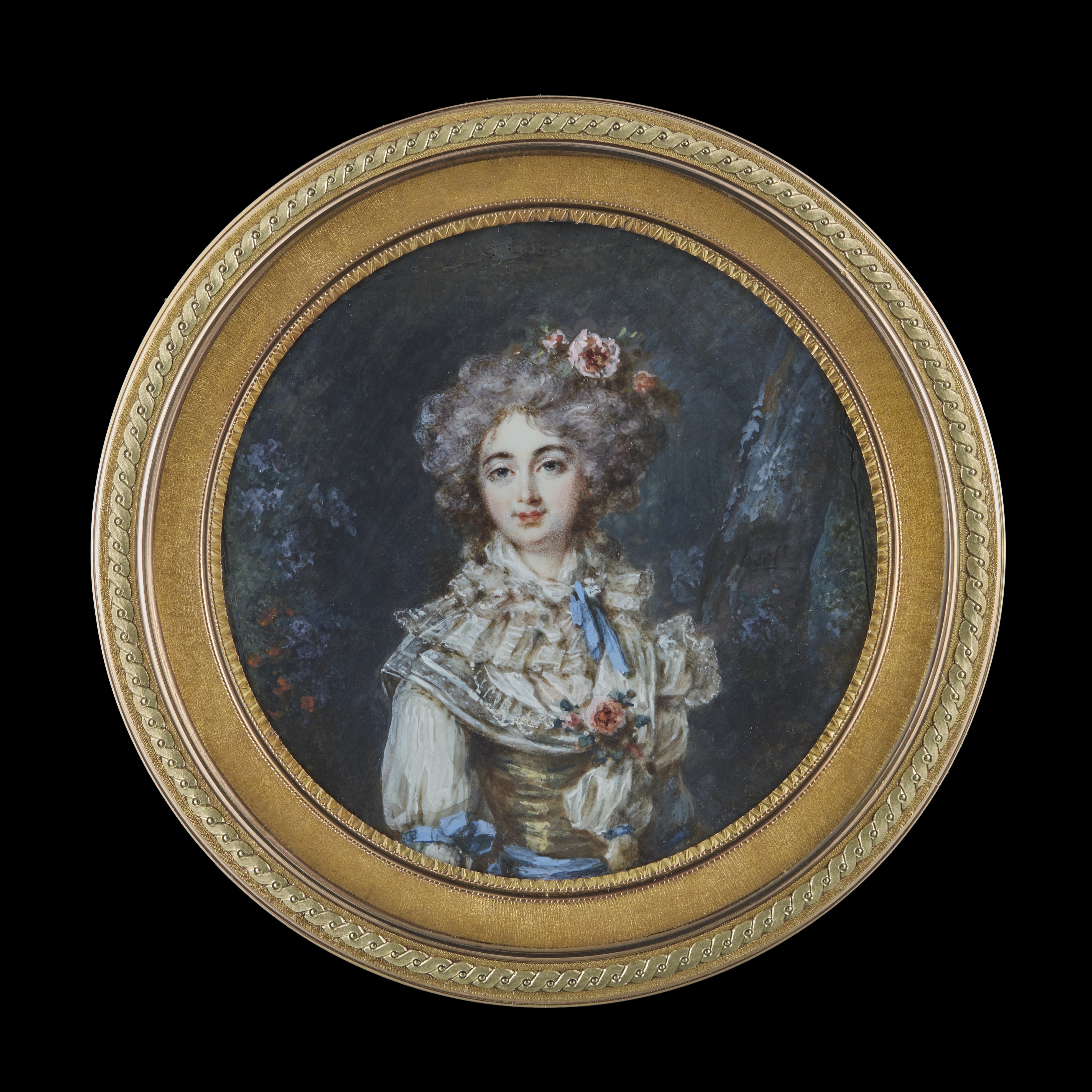 Portrait miniature of a Lady, standing in a wooded landscape, wearing a white dress with a tiered lace collar and yellow bodice, decorated with bright blue ribbons, flowers in her hair and at her corsage