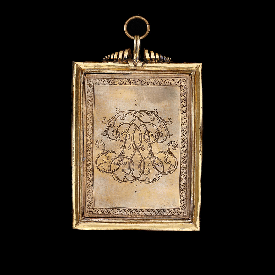 Portrait of a gentleman, called Leonhardus Baur (b.1529), aged twenty, resting on a table covered with red cloth, wearing a black doublet, sleeves slashed to reveal white, and a brown coat, sleeves slashed to reveal maroon, white shirt tied with black ribbon, and a black cap with gold and silver pins; a merchant’s symbol and memento mori to the top left