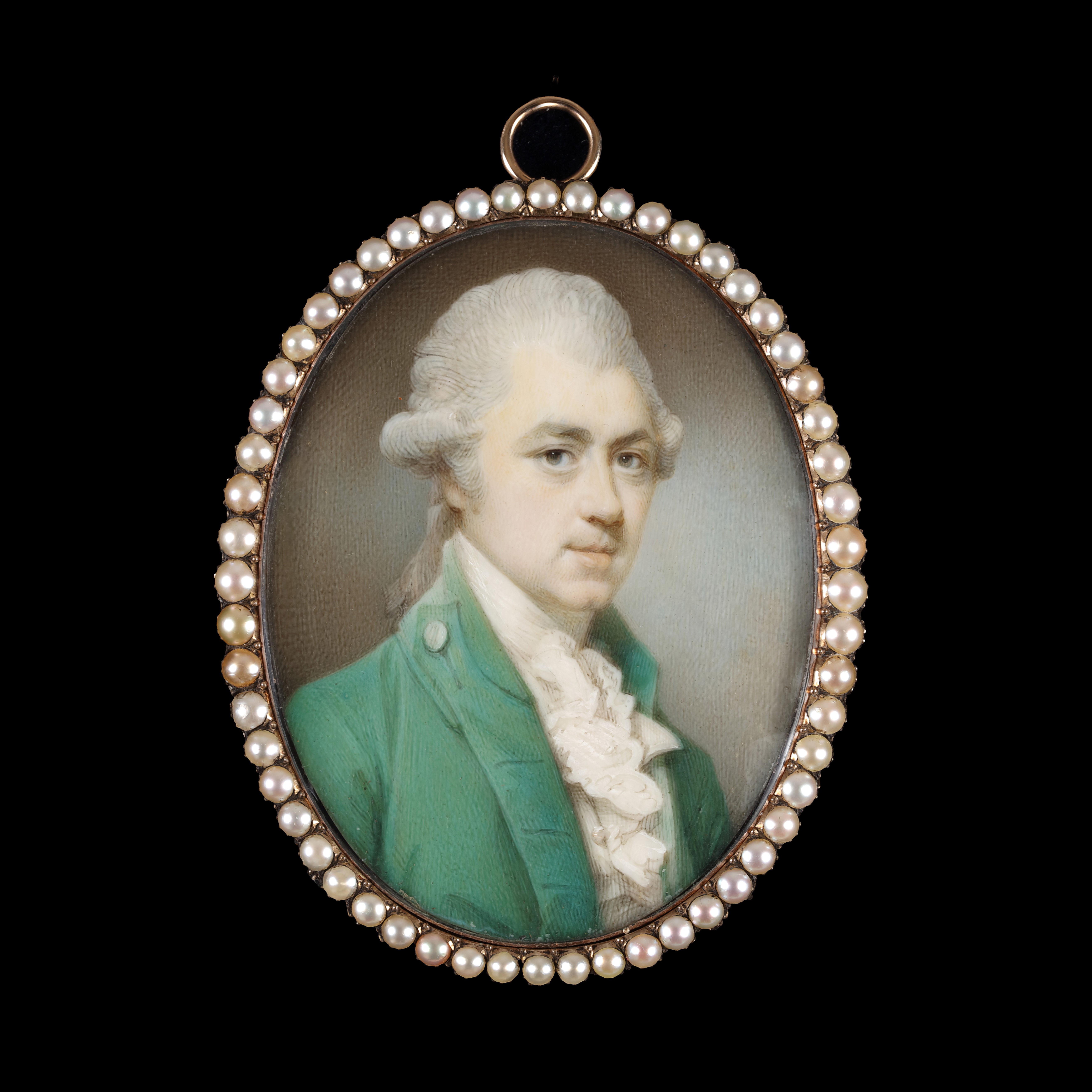 Portrait miniature of a Gentleman wearing a green coat, white waistcoat and jabot, his powdered hair worn en queue; circa 1775