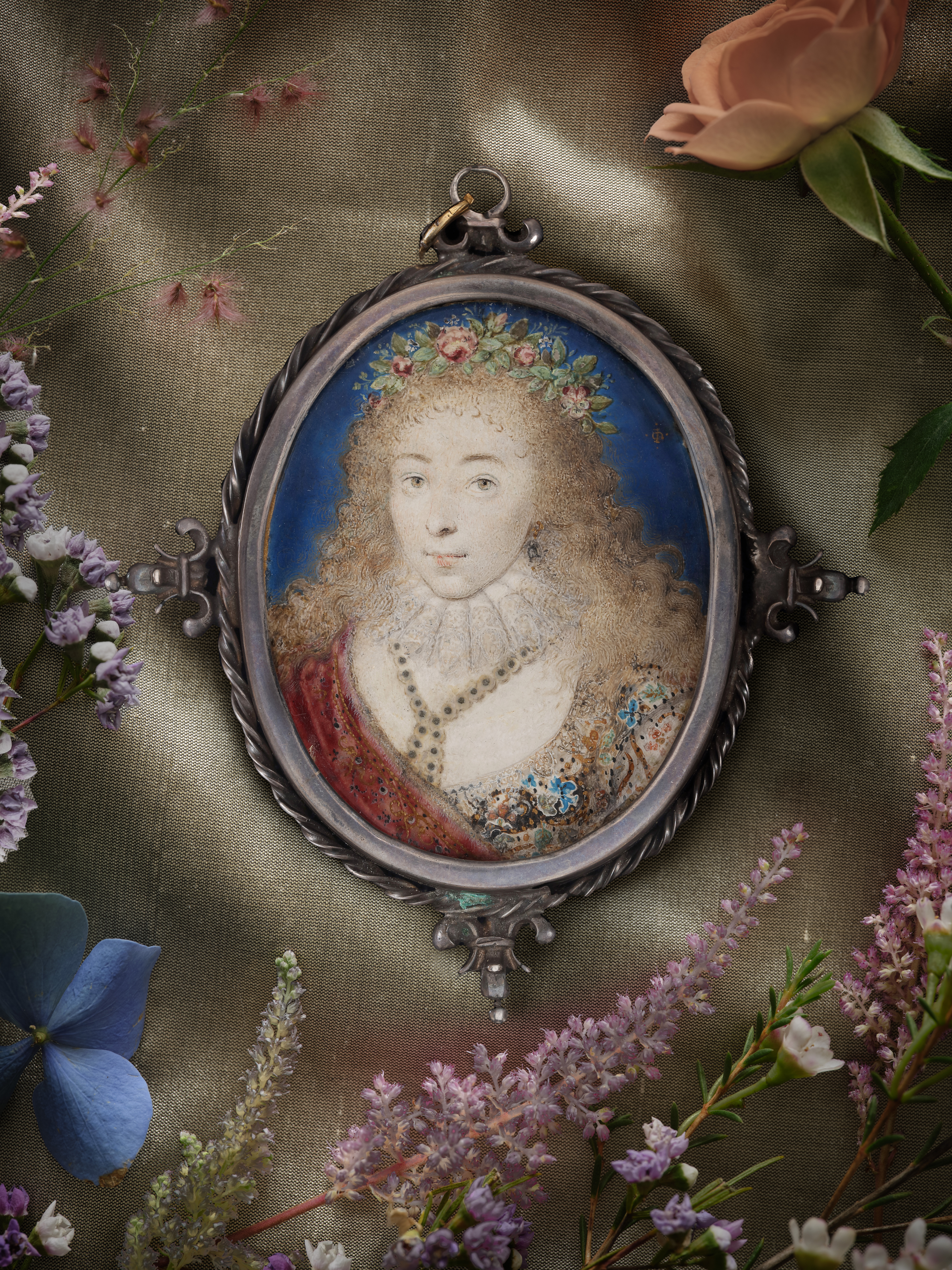 Portrait miniature of Lady Dorothy Sidney (née Percy) (c.1598-1659), later Countess of Leicester, wearing elaborate embroidered dress, pearl necklace and earring, a garland of fresh flowers in her loose blonde hair