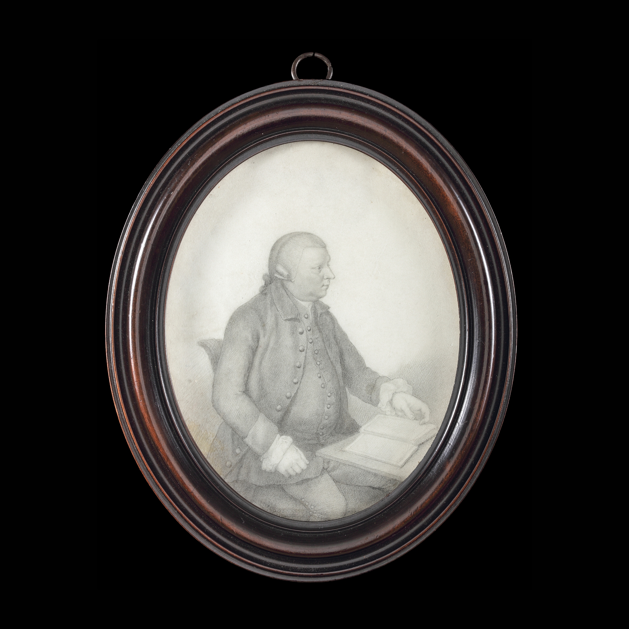 Portrait drawing of Charles Nicholas Cochin (1715-1790), seated, facing to the right in a coat and waistcoat, with an open book on a table